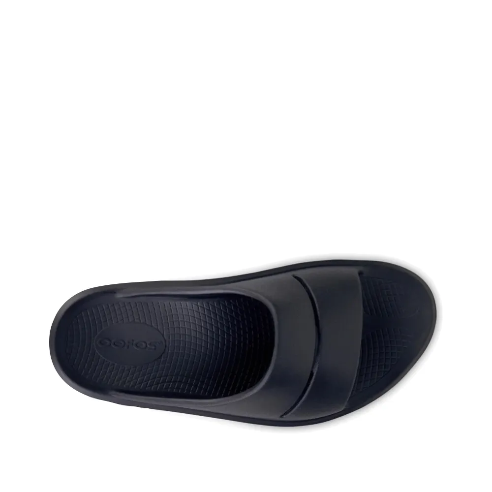 OOfos OOmega OOahh Slide Sandal in Black